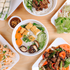 Variety of Vietnamese dishes including Pho with tofu, spring rolls, and stir-fry.